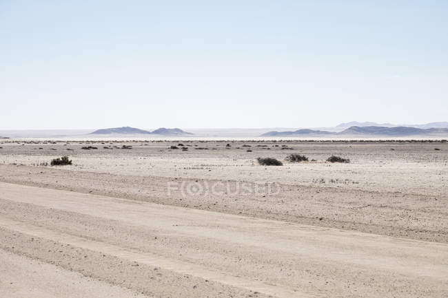 Africa, Namibia, Namib desert, gravel road in front of landscape — Stock Photo