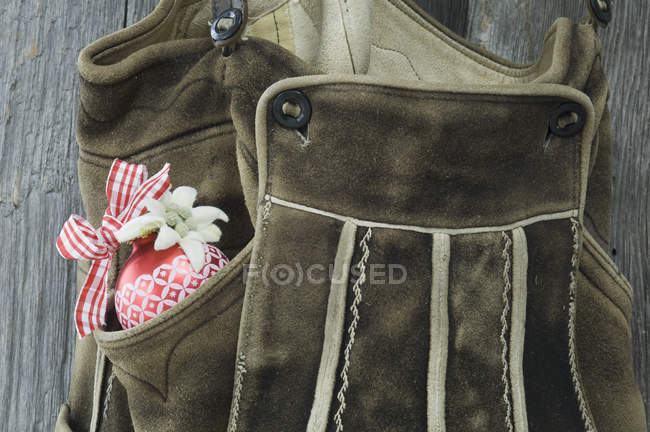 Bavarian leather trousers with Christmas bauble and Edelweiss — Stock Photo
