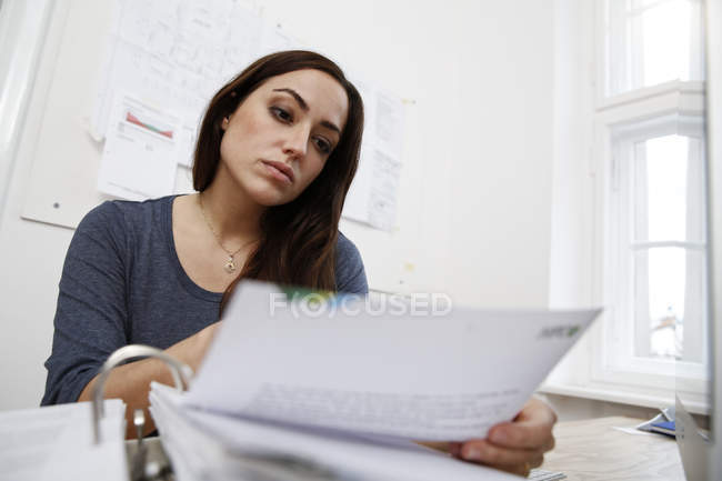 Woman Working On Files At Office Desk Color Image One Person