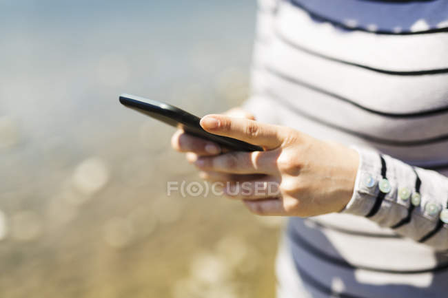 Woman's hands holding smartphone — Stock Photo