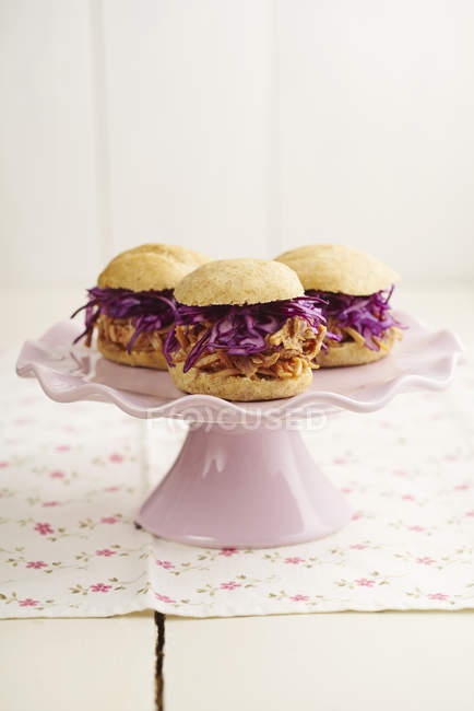 Mini-Burger with pulled pork, red cabbage and fried onions on cake stand — Stock Photo