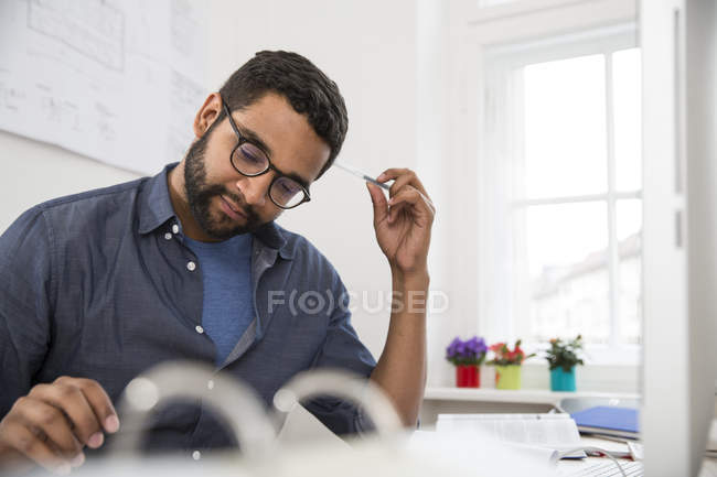 Young man working at desk in office — Stock Photo