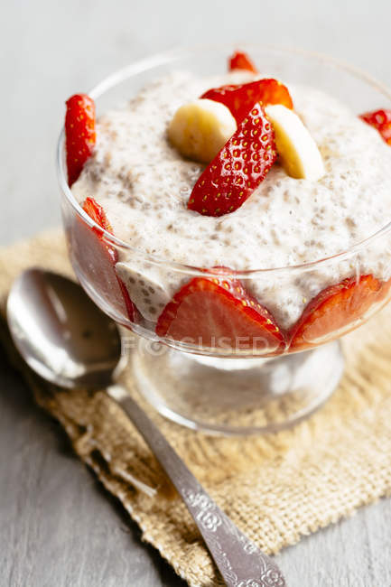 Glass of banana chia pudding with strawberries — Stock Photo