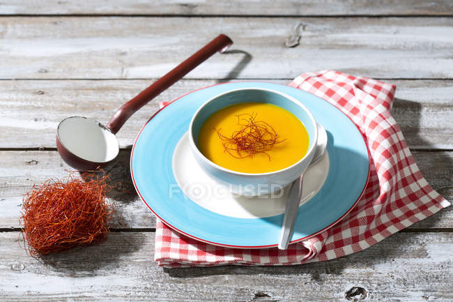 Hokkaido soup and chili threads in soup bowl placed on napkin at wooden table — Stock Photo