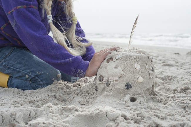 Denmark, Jutland, Vejers, girl building sandcastle — Stock Photo