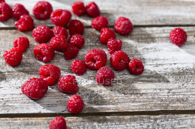 Fresh ripe Raspberries on rustic wooden table — Stock Photo
