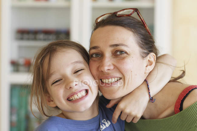 Portrait of smiling Daaughter embracing mother — Stock Photo