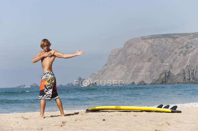 Surfer stretching at beach — Stock Photo