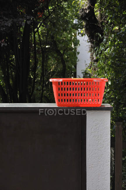 Empty red hamper on wall outdoors — Stock Photo