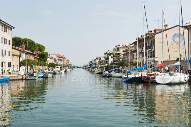 Italy, Friuli, Grado, Moored boats in canal — Stock Photo