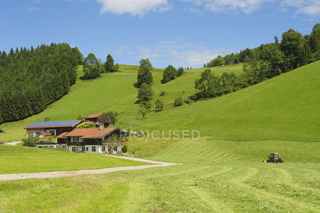Distant view of village houses with alps at daytime, Bavaria, Germany, — Stock Photo