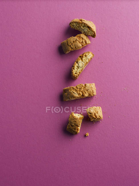 Cantuccini pieces on pink background — Stock Photo