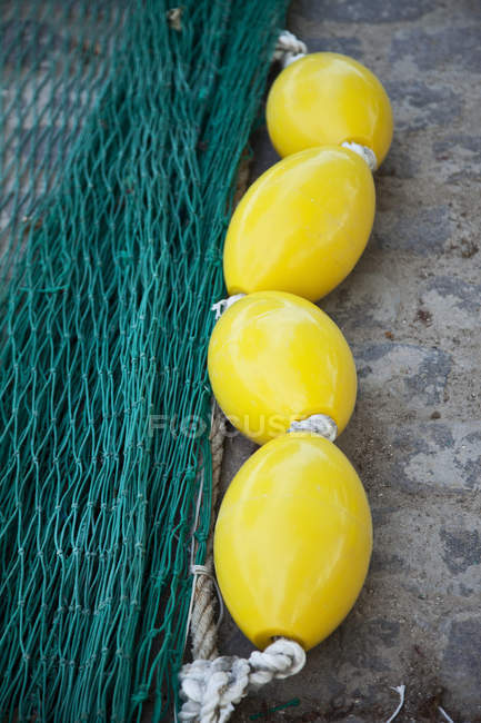 Primer plano de la red de pesca y flotadores amarillos - foto de stock