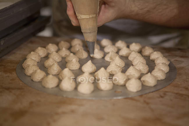 Closeup of professional baker making cookies — Stock Photo