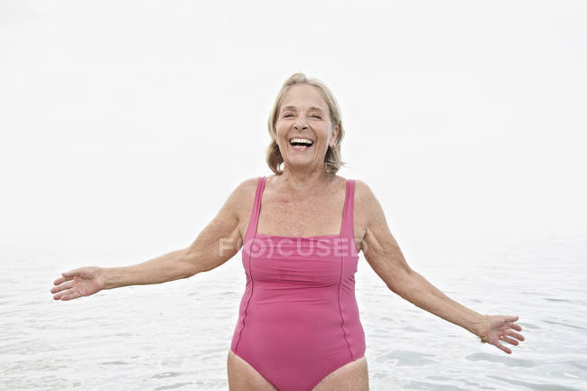 Senior woman on beach at Atlantic ocean — Stock Photo