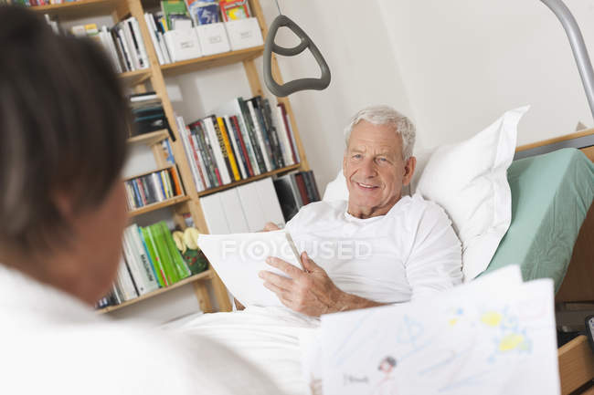 Senior man lying on medical bed — Stock Photo