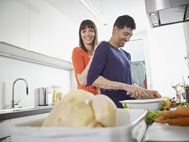 Man and woman cooking together in kitchen — Stock Photo