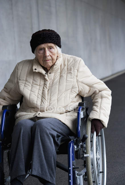 Senior woman on wheelchair at Subway — Stock Photo