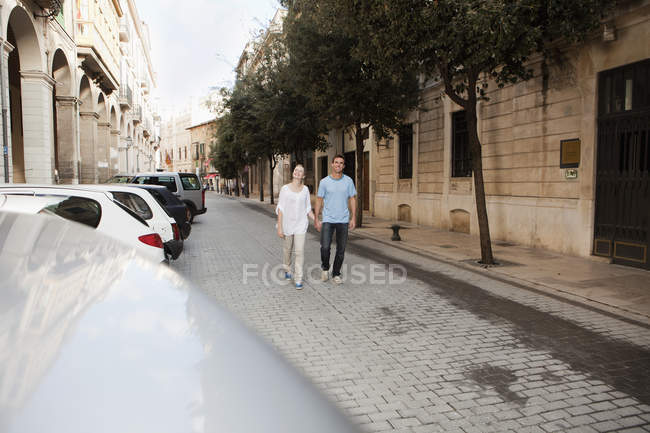 Spain, Mallorca, Palma, Couple walking along street — Stock Photo