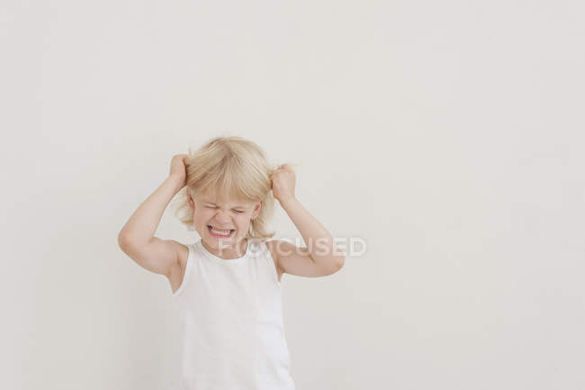 En colère petit garçon déchirant les cheveux — Photo de stock