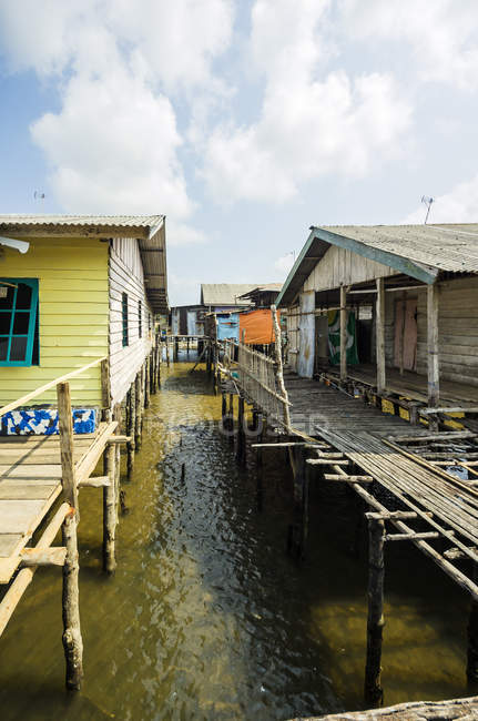 Indonesia, Riau Islands, Bintan Island, Fishing village, Wooden huts over water — Stock Photo