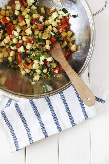 Preparing vegetable paella in metal bowl — Stock Photo