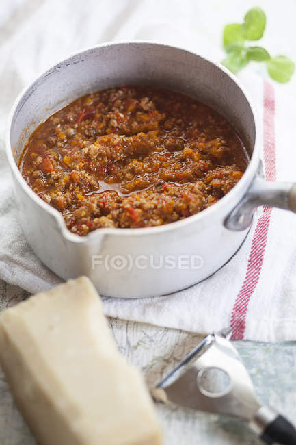 Bolognese sauce in pot with Parmesan cheese — Stock Photo