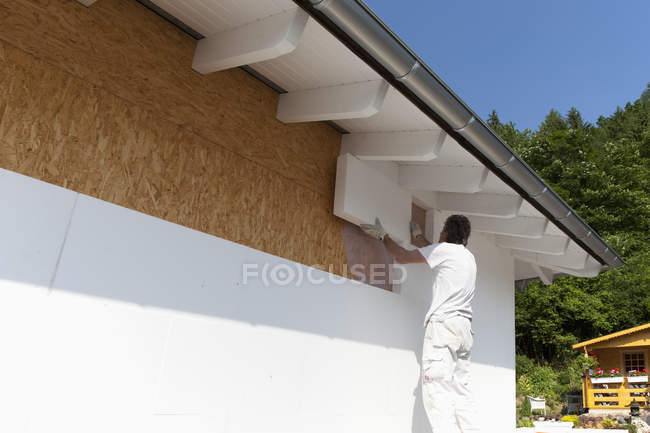 Man insulating polystyrene on construction site — Stock Photo
