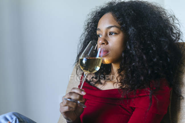 Portrait of woman drinking glass of white wine — Stock Photo
