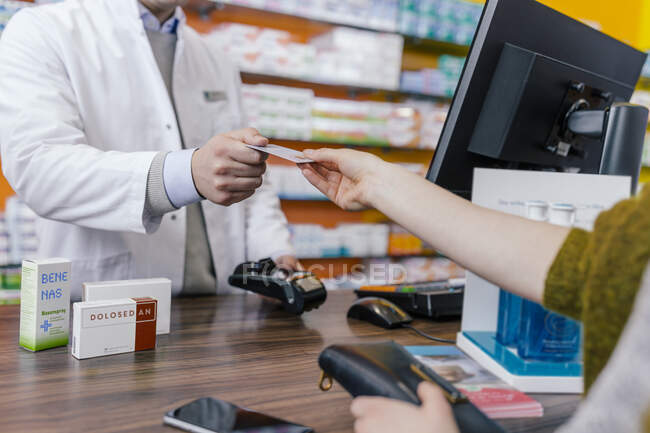 Customer paying cashless in a pharmacy — Stock Photo