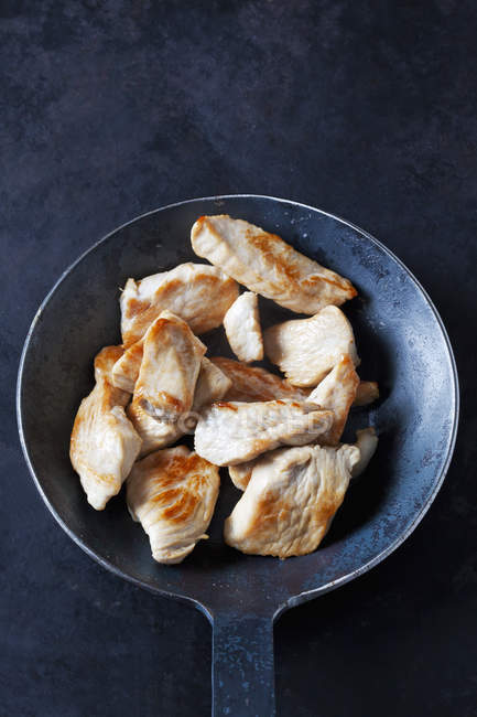 Fillet of turkey in frying pan — Stock Photo