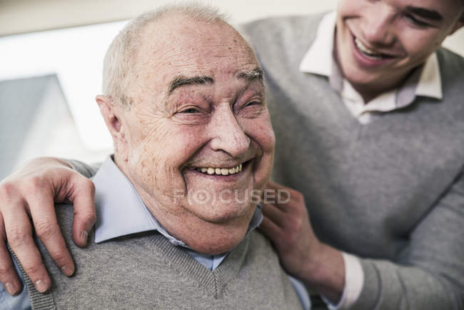 Portrait of happy senior man with young man — Stock Photo