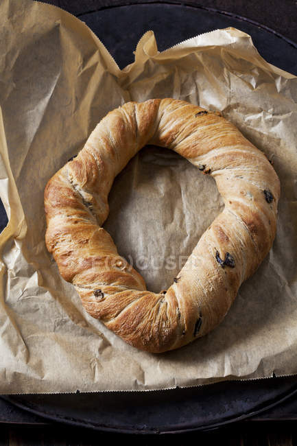 Ring bread with black olives on paper — Stock Photo