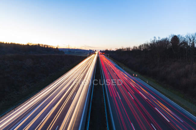 Germany, Baden-Wuerttemberg, Autobahn A8 near Wendlingen in the evening, light trails — Stock Photo