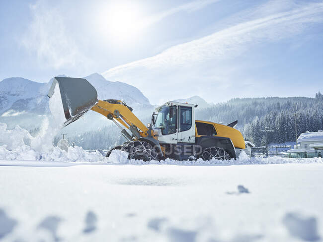 Austria, Tirol, Hochfilzen, servicio de arado de nieve, espacio libre de nieve con cargador de ruedas - foto de stock
