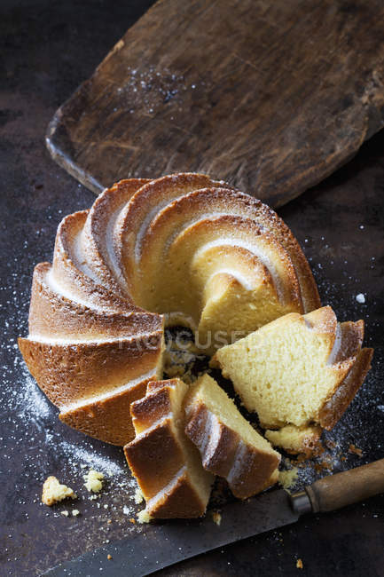 Sliced Gugelhupf sprinkled with icing sugar — Stock Photo