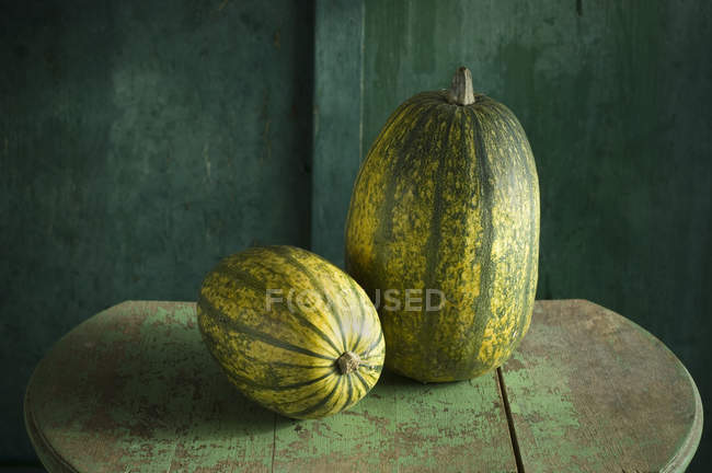 Fresh pumpkins on rustic wooden background — Stock Photo
