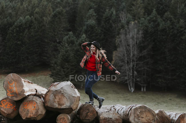 Young woman balancing on logs — Stock Photo