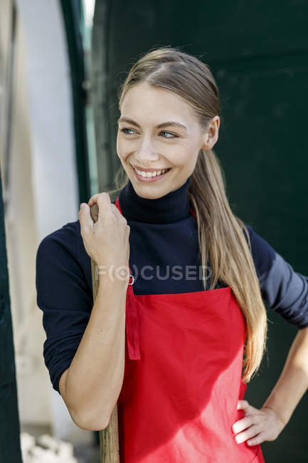 Portrait of smiling young wearing apron — Stock Photo