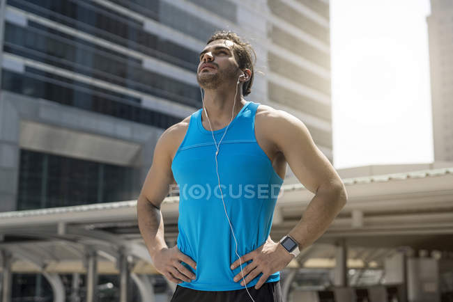 Handsome Runner taking break in city — Stock Photo