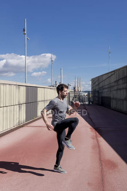 Sportive man exercising outdoors between walls — Stock Photo
