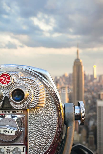 USA, New York, Manhattan, Close up of telescope, Empire State Building ...