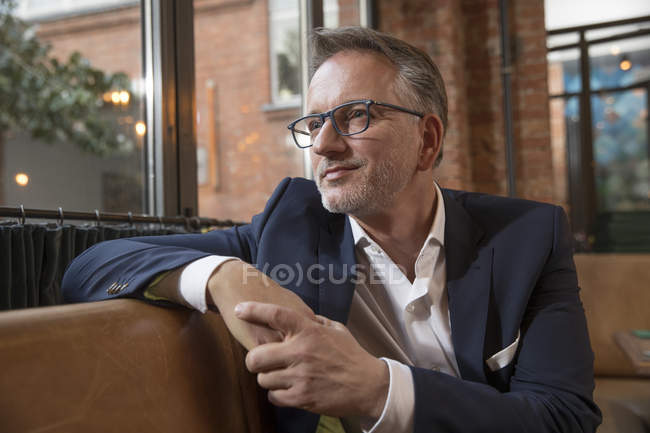 Porträt eines nachdenklichen Geschäftsmannes, der in einem Restaurant wartet — Stockfoto