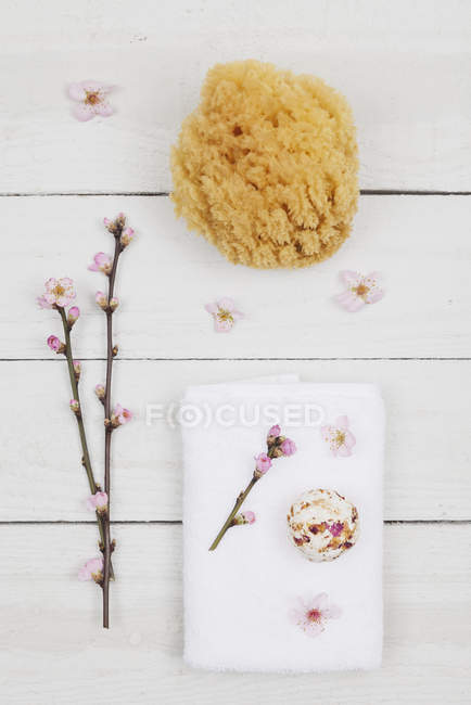 Cherry blossom soap ball on towel with natural sponge — Stock Photo