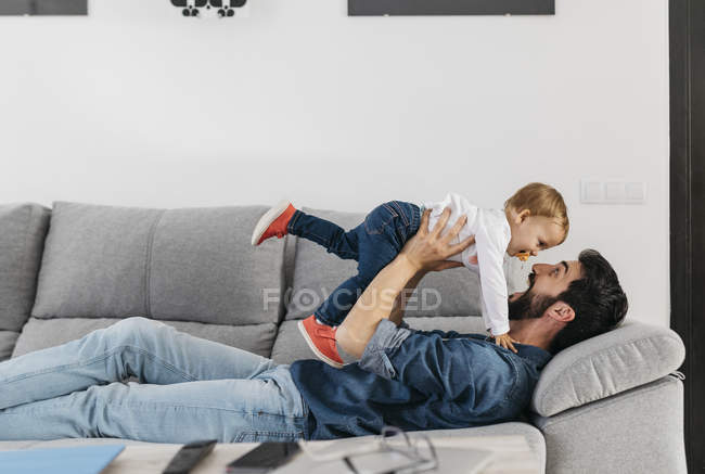 Father playing with his daughter at home — Stock Photo