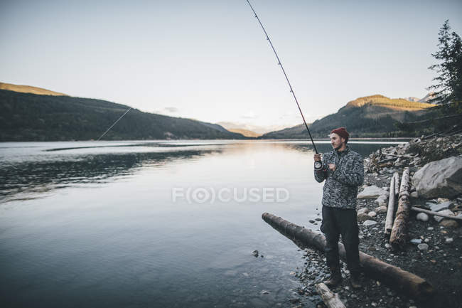 Canada, British Columbia, man fishing at Kinbasket Lake — стокове фото