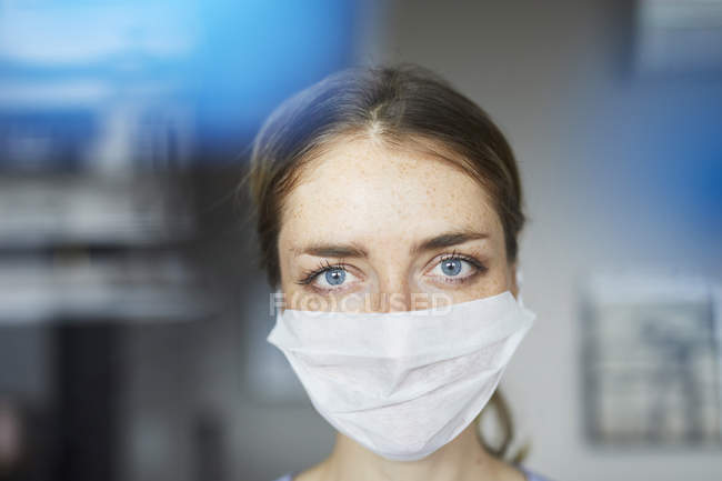 Portrait of woman wearing surgical mask — Stock Photo