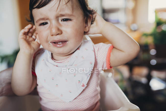 Portrait of crying baby girl at home — Stock Photo