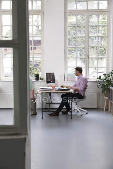 Man Working At Desk In A Loft Office Copy Space One Person