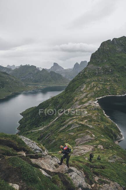Norway, Lofoten, Moskenesoy,  Group of young men hiking at Vinstad — Stock Photo